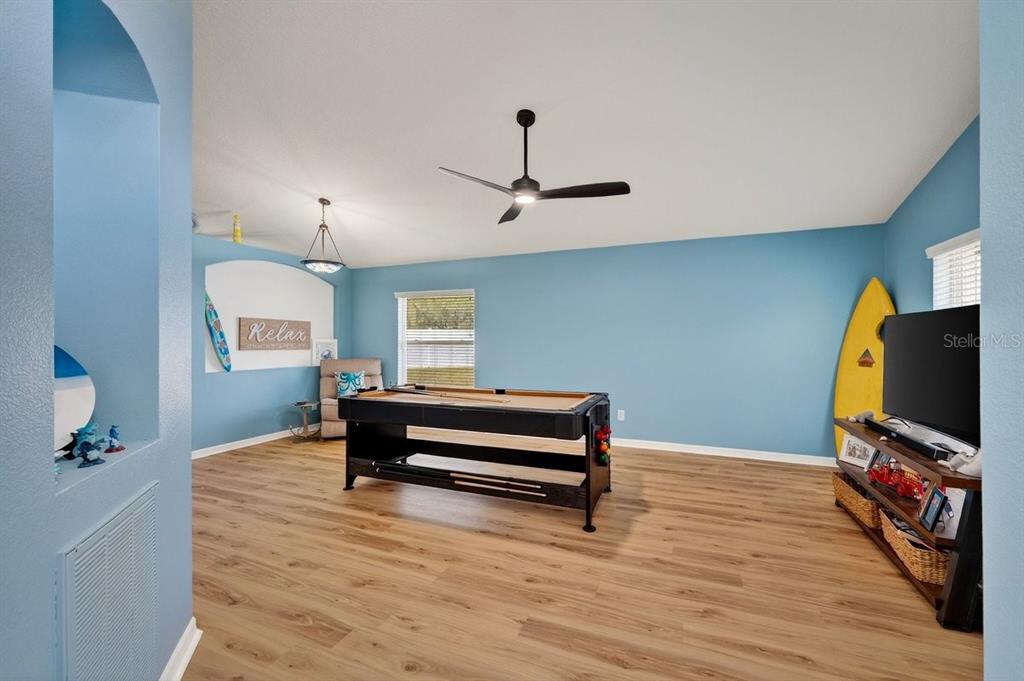 630 Fawn Ridge Drive Orange City, FL 32763 - Photo 5 of 55 a living room with furniture and a flat screen tv