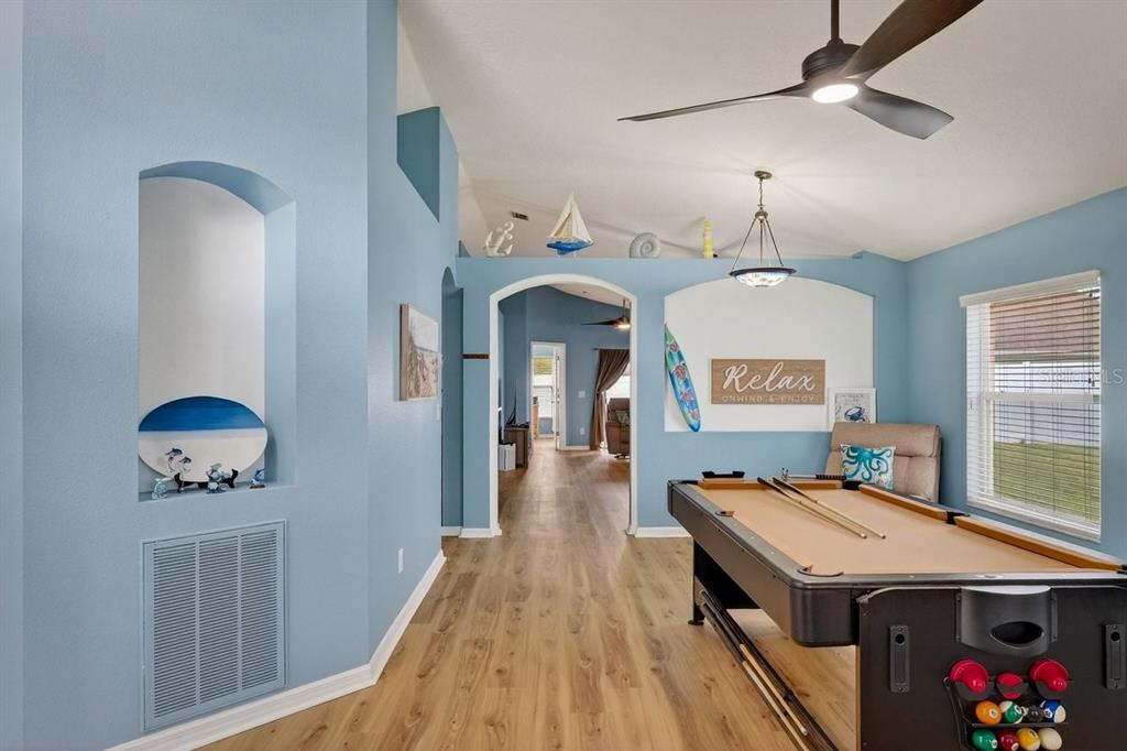 630 Fawn Ridge Drive Orange City, FL 32763 - Photo 6 of 55 a living room with a dining table wooden floor and a chandelier