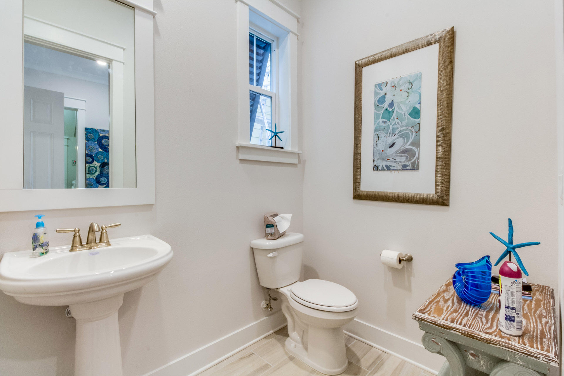 89 East Pine Lands Loop, Unit A Inlet Beach, FL 32461 - Photo 3 of 40 a bathroom with a toilet sink and mirror