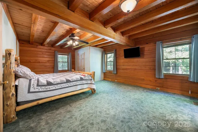a bed sitting in a spacious bedroom next to a window