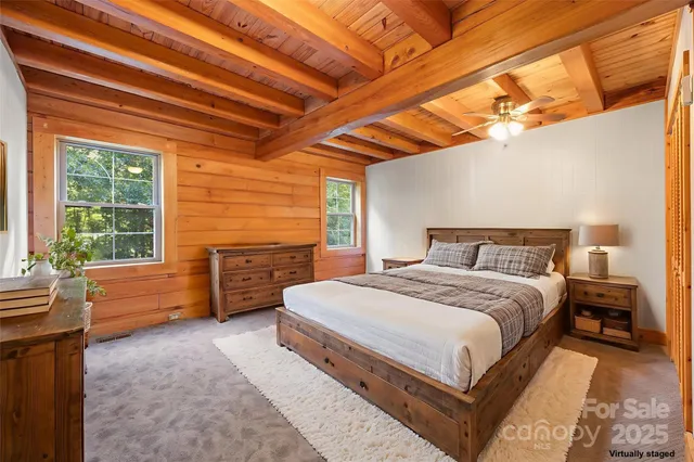 a large bed sitting in a bedroom next to a window