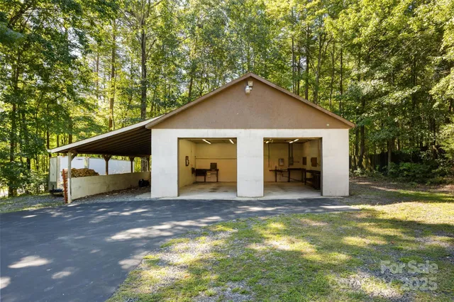 a view of a house with a yard balcony and tree