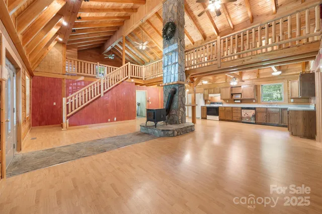 a view of a room with wooden floor and windows