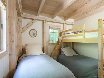 a bedroom with bed and a chair