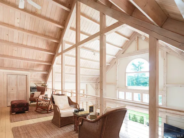 a living room with furniture and floor to ceiling windows