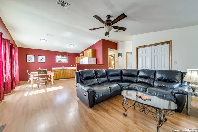 a living room with furniture and a wooden floor