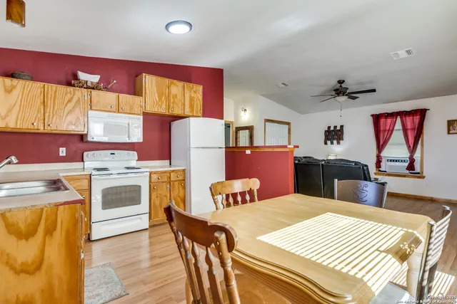 a kitchen that has a cabinets counter space appliances and a window