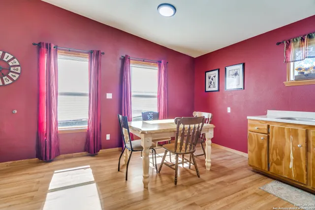 a view of a dining room with furniture and window