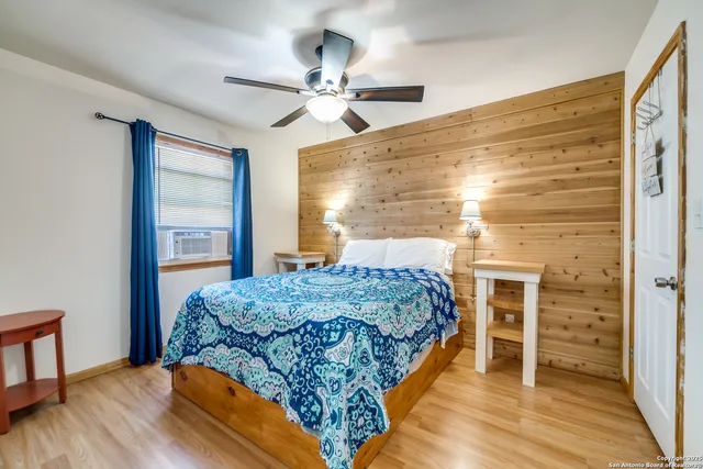 a living room with a bed furniture and a window