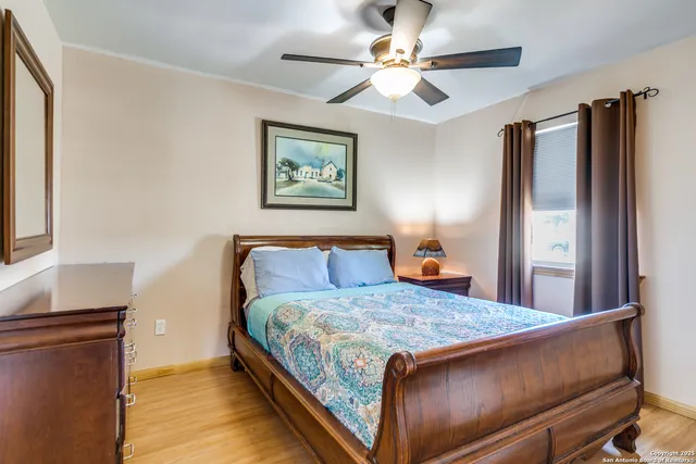 a bedroom with a large bed and a window