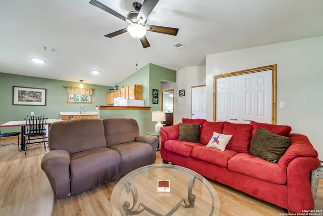 a living room with furniture ceiling fan and a rug