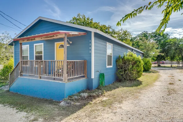 a view of a house with a small yard