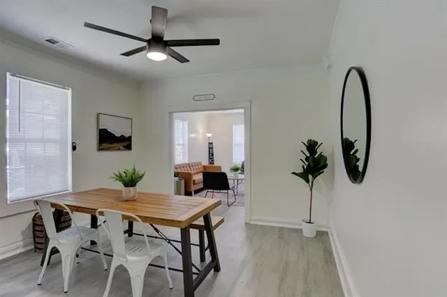 a view of a dining room with furniture and a potted plant