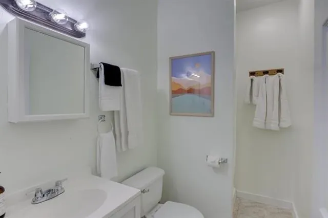 a bathroom with a toilet sink and shower