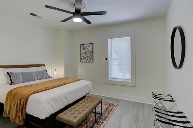 a bedroom with a bed and a window