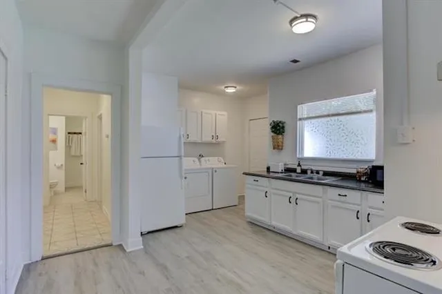 a kitchen with granite countertop a sink stove and cabinets