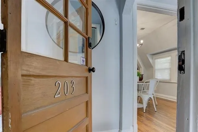 a view of a hallway with wooden floor and entryway