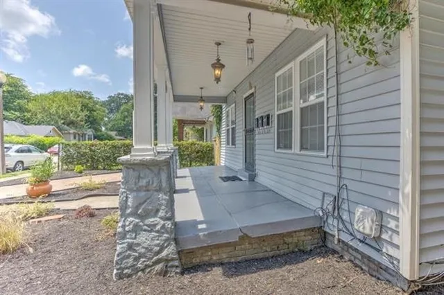 a view of a patio with table and chairs and potted plants