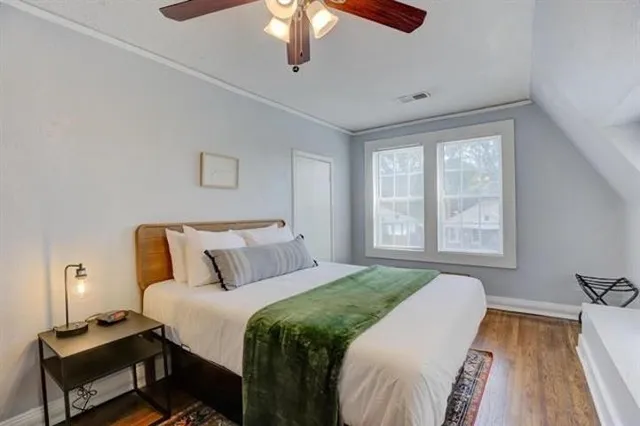 a bedroom with a bed and wooden floor