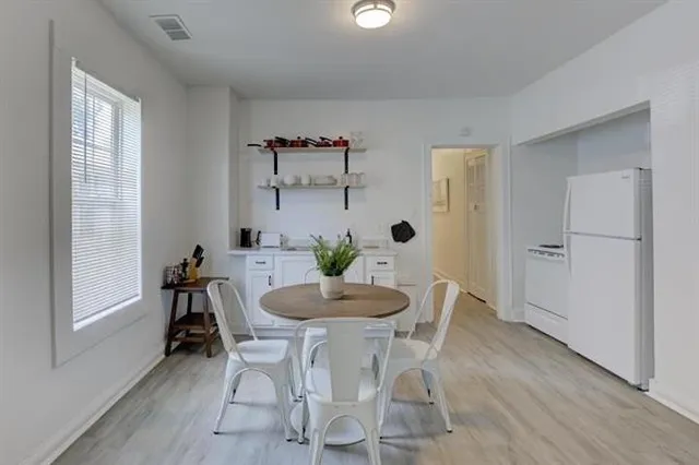 a dining room with furniture and window