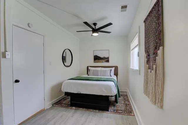 a bedroom with a bed and a chandelier