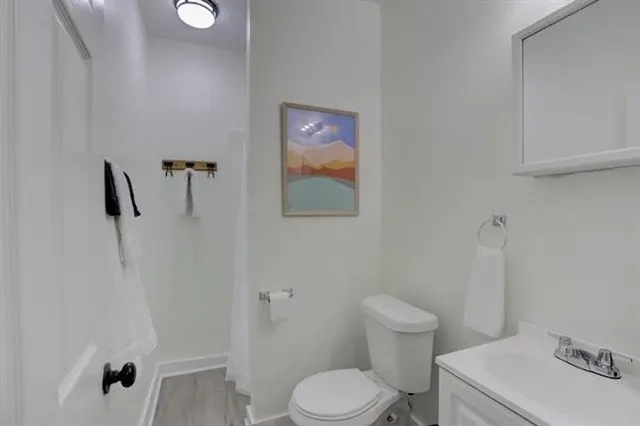 a white toilet sitting next to a bathroom sink