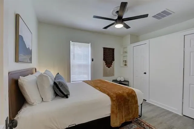 a bedroom with a bed and a ceiling fan