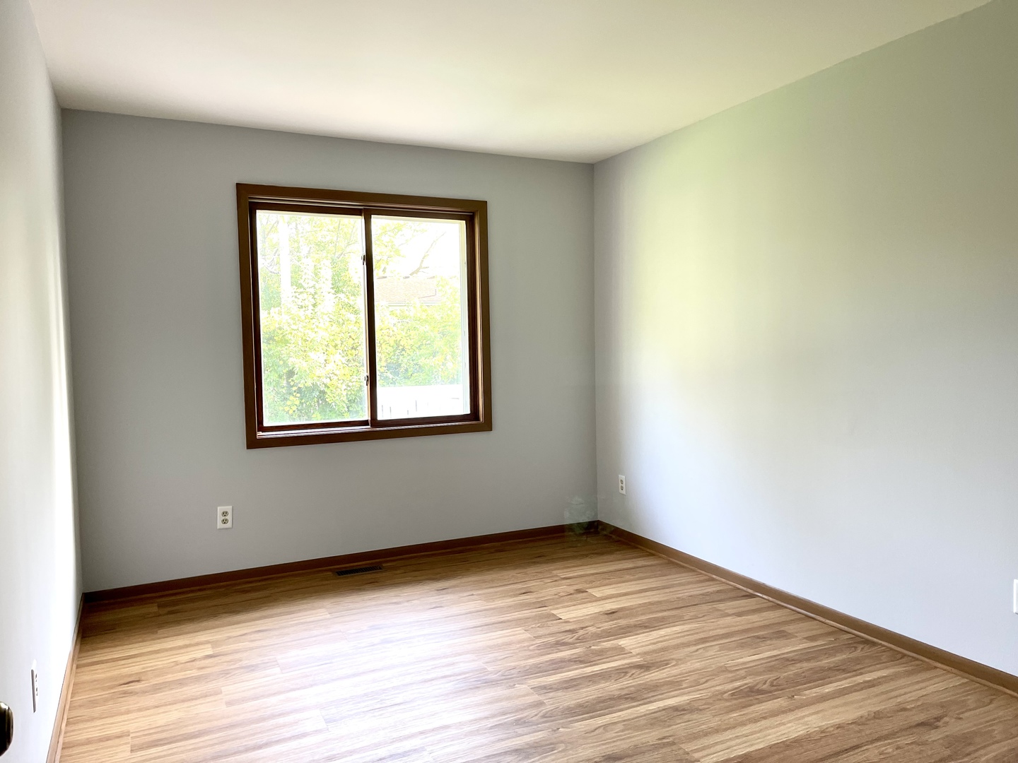 1277 Getzelman Drive Elgin, IL 60123 - Photo 14 of 20 an empty room with wooden floor and windows