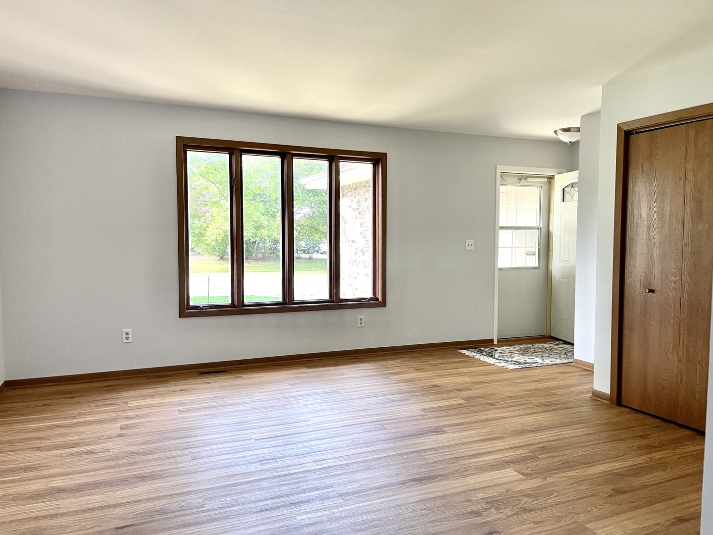 1277 Getzelman Drive Elgin, IL 60123 - Photo 2 of 20 an empty room with wooden floor and windows