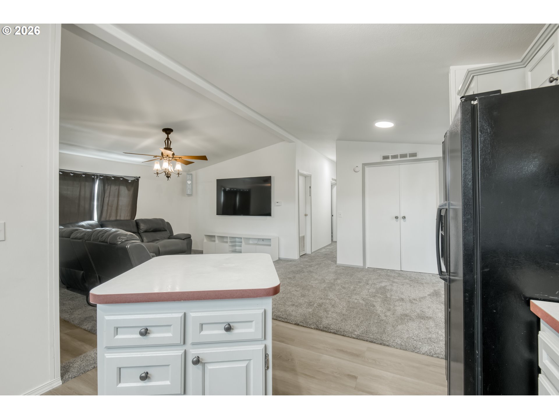 513 Rose Avenue Vernonia, OR 97064 - Photo 7 of 19 a kitchen with a refrigerator and a flat screen tv