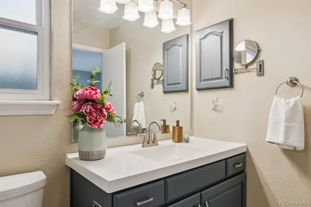 a bathroom with a sink vanity and mirror