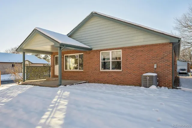 a view of an house with backyard and a porch