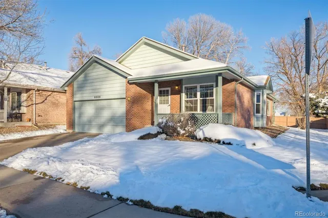 a view of a house with backyard and snow