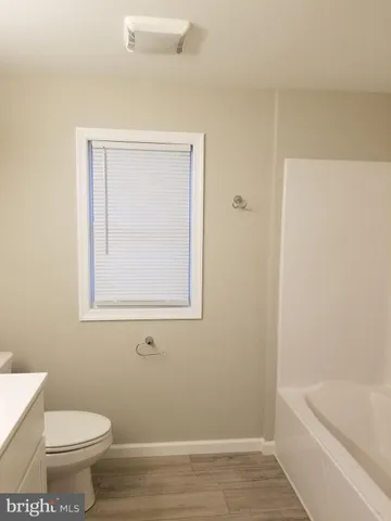 a bathroom with a toilet and a bathtub