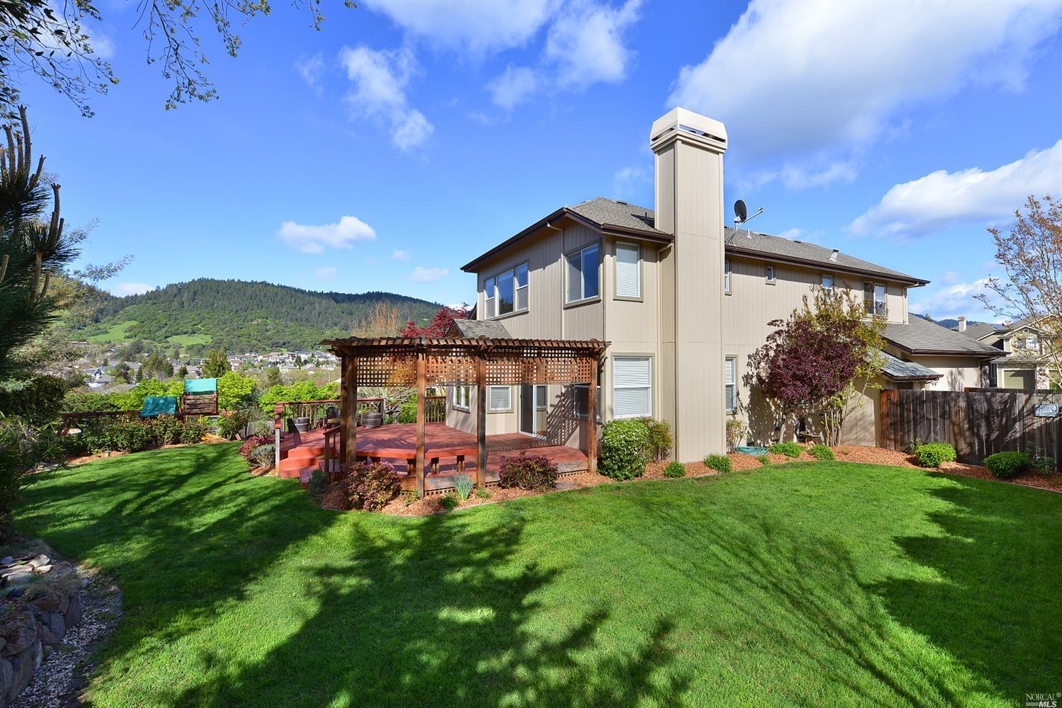 1460 Hawk Crest Place Santa Rosa, CA 95409 - Photo 1 of 1 a view of a house with a big yard potted plants and large tree