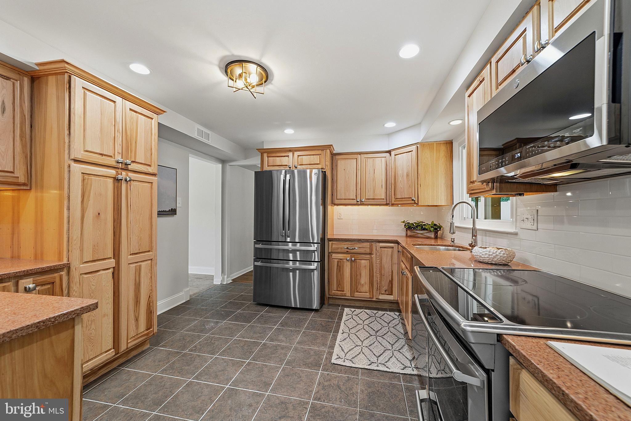 117 Harvest Road Cherry Hill, NJ 08002 - Photo 18 of 35 a kitchen with stainless steel appliances granite countertop a sink stove and refrigerator
