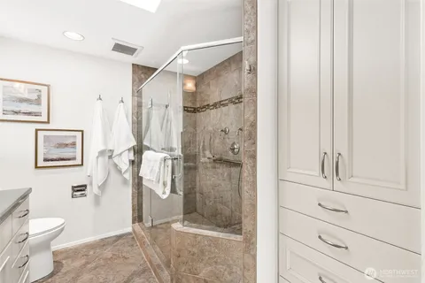 a bathroom with a shower and a toilet