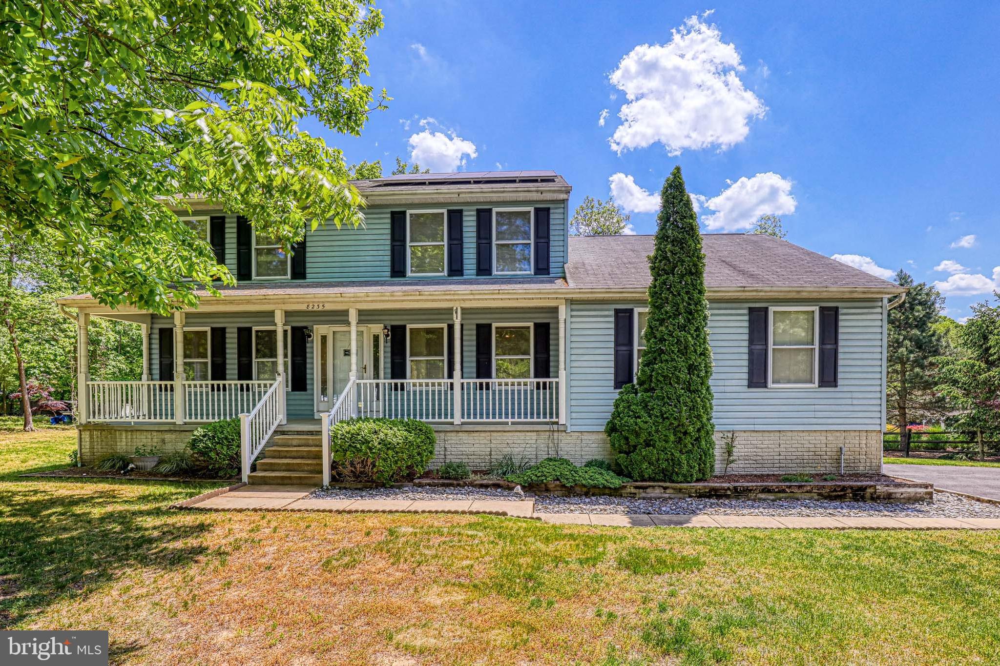 8235 Quarterfield Road Severn, MD 21144 - Photo 1 of 34 a front view of a house with a yard and potted plants