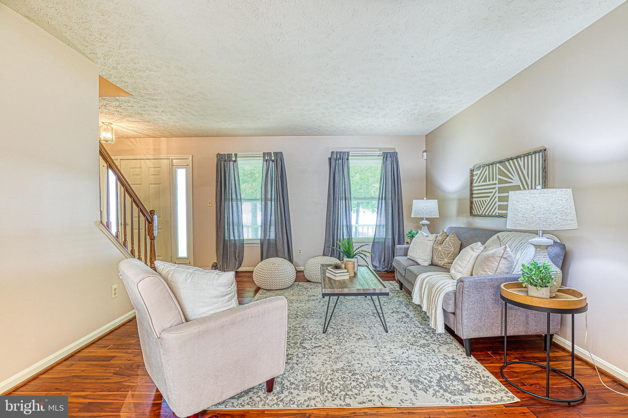 8235 Quarterfield Road Severn, MD 21144 - Photo 5 of 34 a living room with furniture and a table
