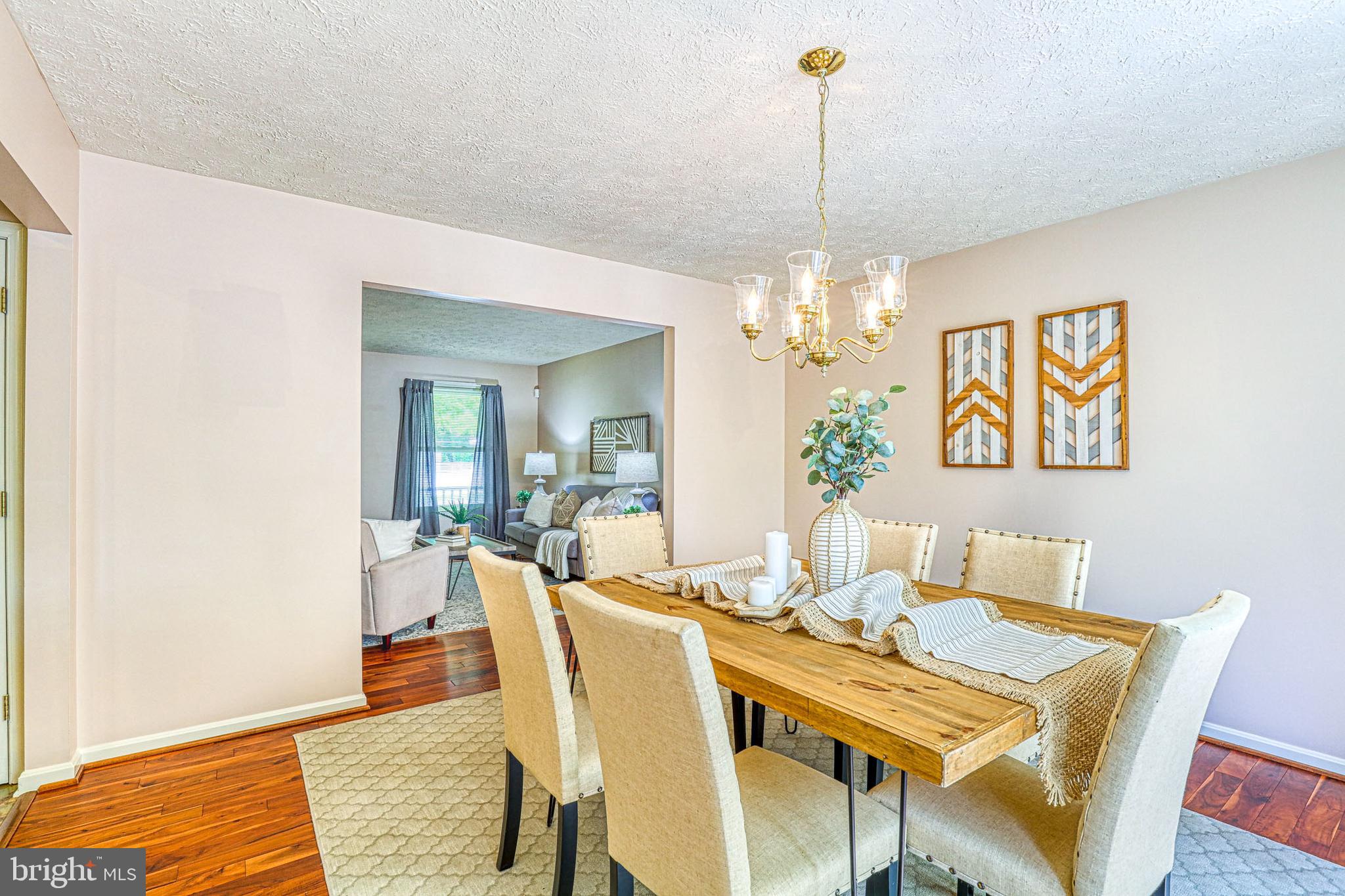8235 Quarterfield Road Severn, MD 21144 - Photo 7 of 34 a view of a dining room with furniture and chandelier