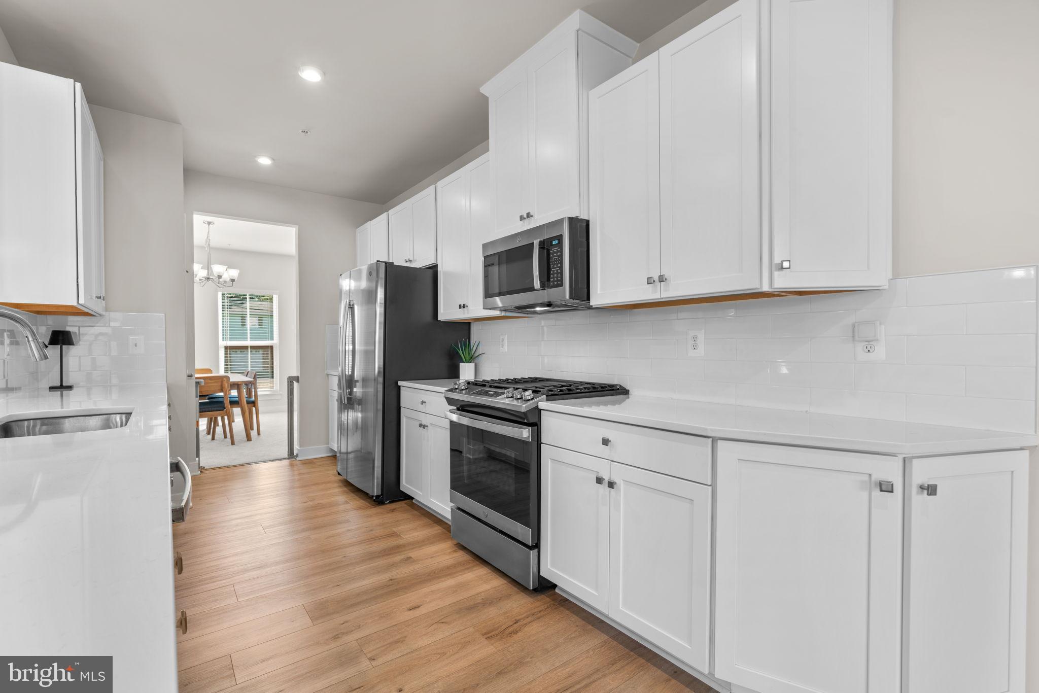 203 Baughmans Lane Frederick, MD 21702 - Photo 12 of 56 Modern kitchen with sleek white cabinetry.