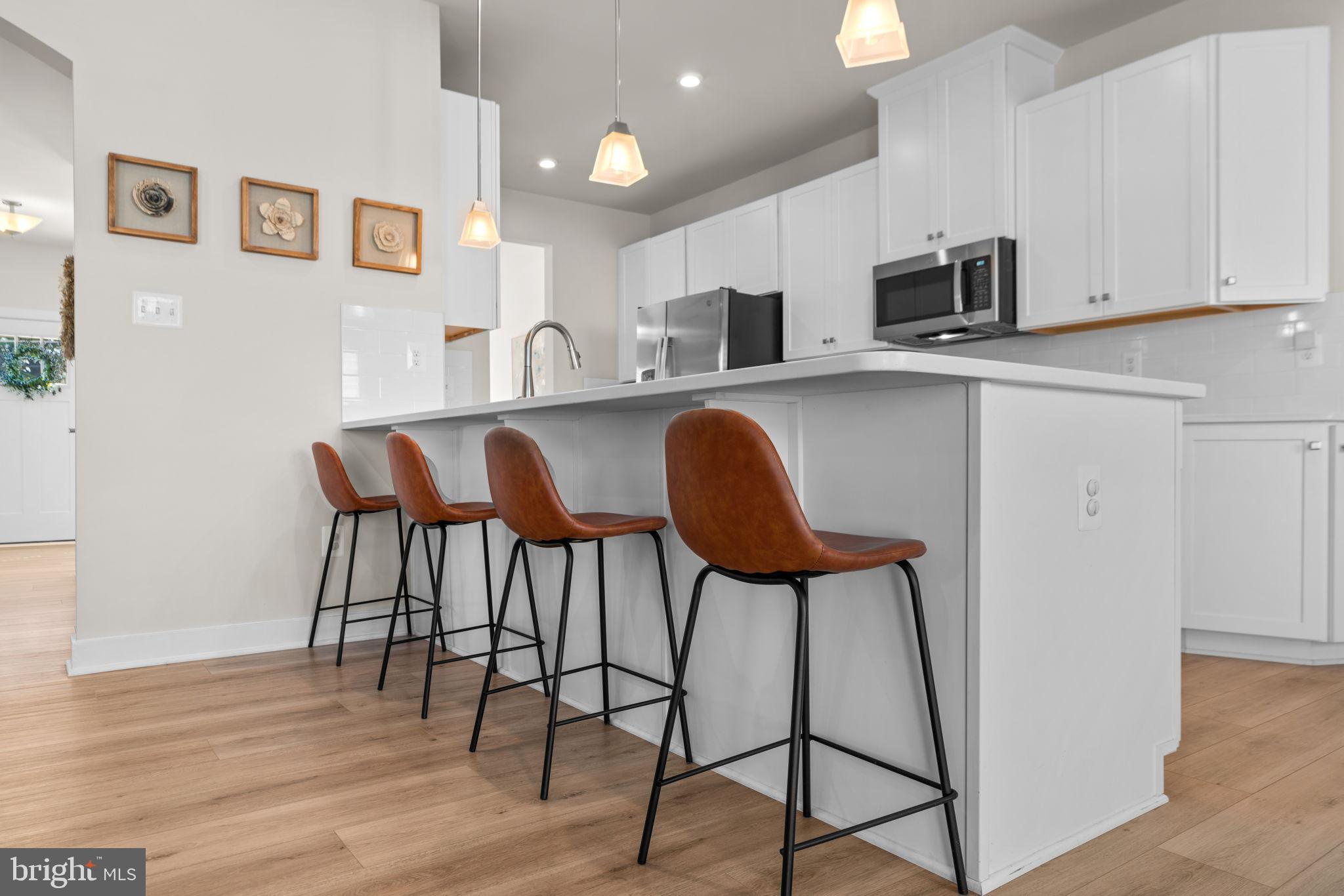 203 Baughmans Lane Frederick, MD 21702 - Photo 14 of 56 Modern kitchen with stylish bar seating.