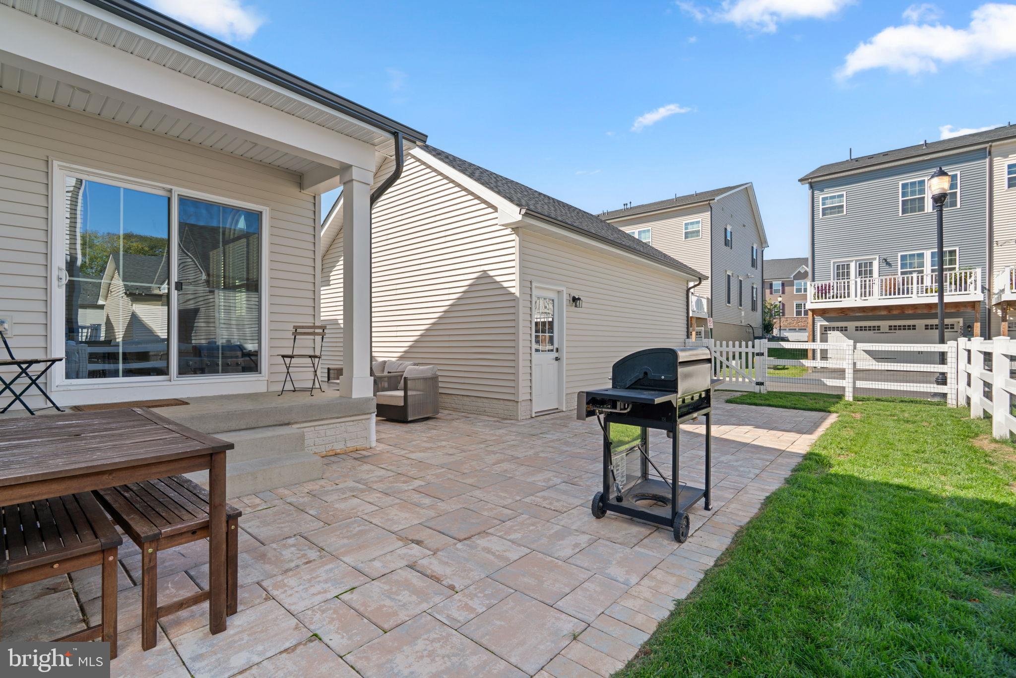 203 Baughmans Lane Frederick, MD 21702 - Photo 51 of 56 Charming backyard oasis with patio and grill.