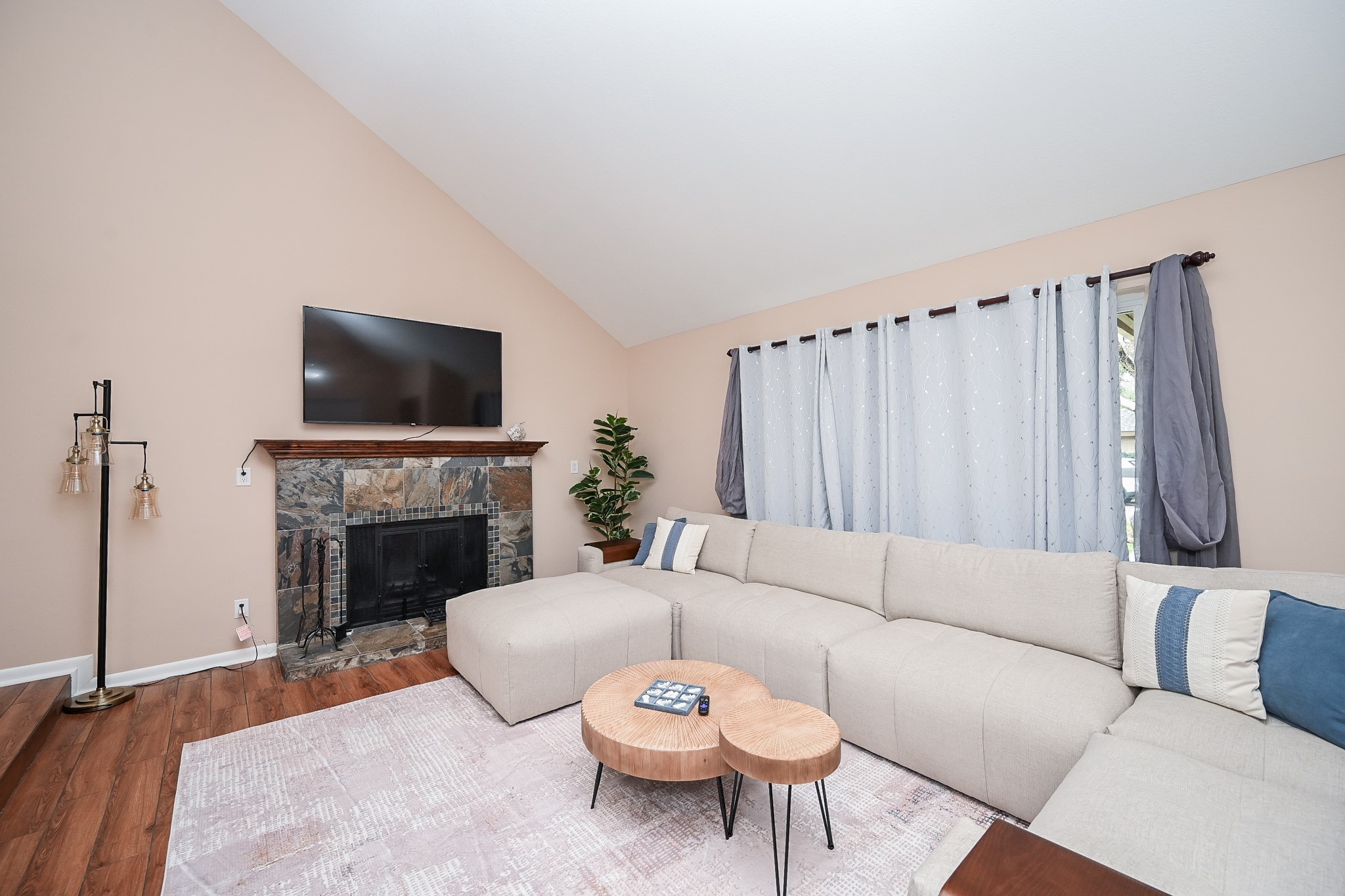 19414 Dianeshire Drive Spring, TX 77388 - Photo 11 of 30 a living room with furniture a fireplace and a flat screen tv