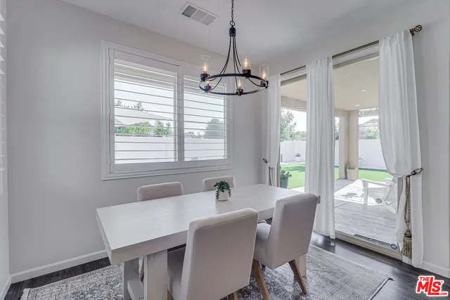 a dining room with furniture and windows