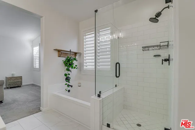 a bathroom with a bathtub and shower