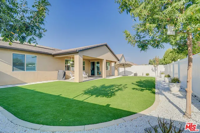 a view of a house with a backyard porch and sitting area