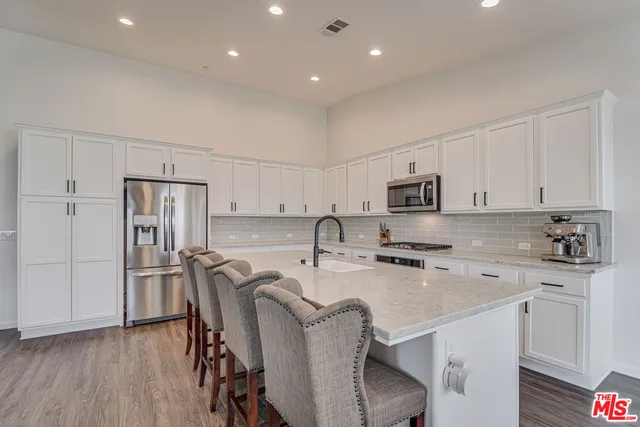 a kitchen with stainless steel appliances a refrigerator stove microwave and cabinets