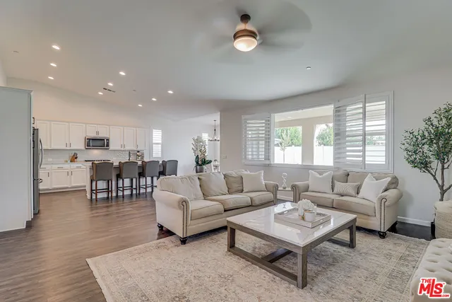 a living room with lots of furniture and a table