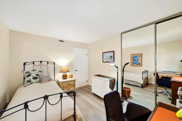 a bedroom with furniture and wooden floor